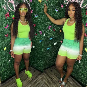 Detail of women's two-piece sports set featuring neon tank top and gradient shorts