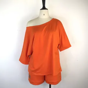 Orange two-piece lounge set featuring a one-shoulder top and matching shorts