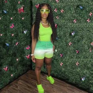 A detailed view of women's neon green racerback tank and ombre gradient shorts set