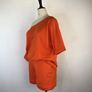 Side view of vibrant orange off-the-shoulder two-piece loungewear set on mannequin