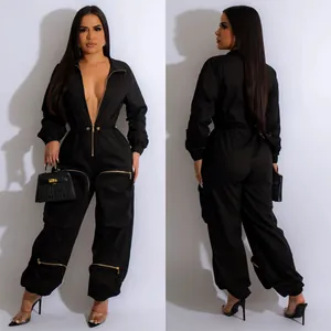 Sleek black long-sleeve utility jumpsuit with gold zipper details and cinched waist