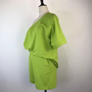 Side view of neon green two-piece lounge set with off-shoulder top and shorts