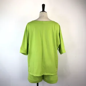 Detailed back view of a trendy lime green sweatshirt and shorts two-piece set for women.