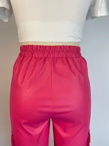 Detailed back view of vibrant pink PU leather trousers with elasticated waist