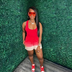 Detailed view of women's red racerback tank top and gradient shorts activewear set