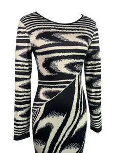 Detail of long sleeve bodycon dress featuring black and white irregular abstract print