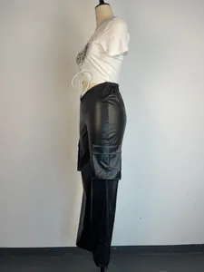 Detail side view of stylish black low-waist PU leather cargo pants with large pockets