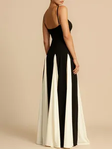 Back view of elegant black and white contrast pleated maxi evening dress with spaghetti straps