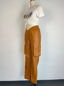 Detail view of brown PU leather cargo pants with low waist and pockets on a mannequin.