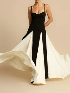 Elegant black and white patchwork evening gown with spaghetti straps and pleated maxi skirt