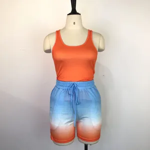 Summer two-piece sports set with orange racerback tank top and gradient shorts on mannequin