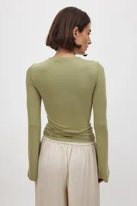 Detailed back view of a slim fit long sleeve olive green top for women in minimalist style