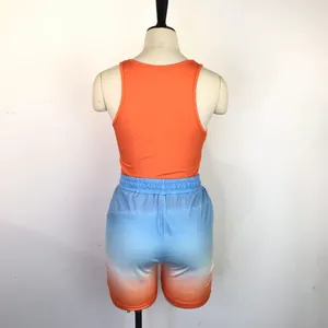 Women's two-piece sports set with orange racerback tank and gradient shorts, back view.