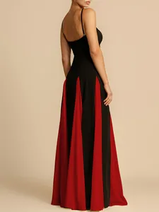Back view of elegant black and red patchwork floor-length evening gown with pleated skirt detail