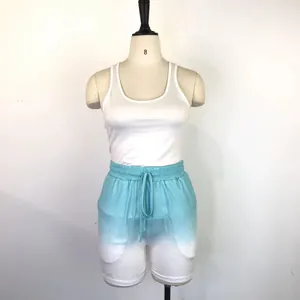 Detail view of women's 2-piece sports set with racerback tank and gradient shorts