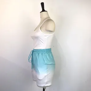 Side view of women's summer sports set with white racerback tank and blue gradient shorts