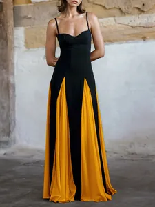 Elegant black and yellow contrast pleat evening gown detail showing draped maxi skirt