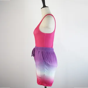 Side detail view of a women's sports set with pink tank top and gradient shorts.