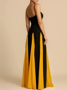 Close-up detail of black and yellow evening dress with spaghetti straps and flared skirt