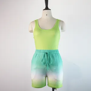 Full view of women's sports set with lime green tank top and ombre shorts
