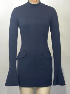 Detail view of navy blue long-sleeve dress with decorative pocket flaps and flared cuffs