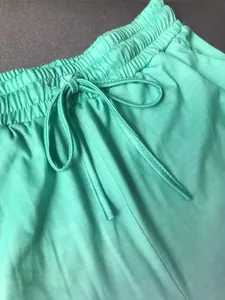Close-up detail of mint green women's sports shorts featuring an elastic drawstring waistband