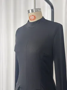 Close-up detail showing the elegant high-neck and slim fit of a black long-sleeved dress