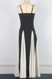 Elegant black and white color block strap maxi dress with flared hem for evening wear