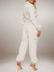 Detailed back view of women's beige cargo jumpsuit with elastic waist and flap pockets