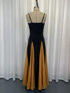 Rear view of an elegant black and mustard yellow color-block camisole maxi dress