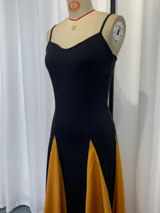 Detailed view of an elegant black and yellow patchwork camisole dress on a professional mannequin.