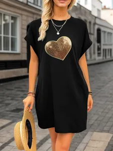 Close-up of a women's black casual t-shirt dress featuring a gold heart sequin embroidery