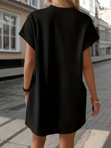 Back view of stylish loose black casual short sleeve dress for women in urban street setting