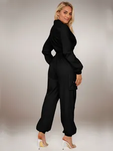 Back view of a black women's cargo jumpsuit with elastic waist and flap pockets.