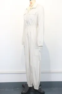 Side view of white women's workwear jumpsuit featuring cargo pockets and elastic waist