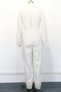 Back view of a stylish women's long-sleeved utility jumpsuit with elastic waist in cream
