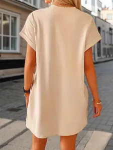 Back view of a loose-fitting beige t-shirt dress with short sleeves for casual outing.