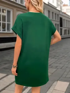 Back view of a stylish loose-fitting emerald green casual short sleeve dress for women