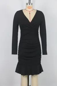Detailed view of elegant black V-neck ruched dress with ruffle hem and long sleeves