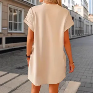 Back view of a women's casual beige short sleeve loose mini dress in stylish street setting