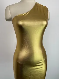 Detailed close-up view of a gold metallic one-shoulder bodycon dress on a mannequin