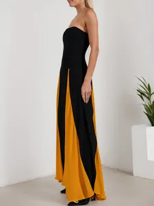 Detail view of the elegant black and mustard yellow color-block strapless evening maxi dress