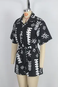 Side view detail of women's short-sleeved romper with black and white tribal print
