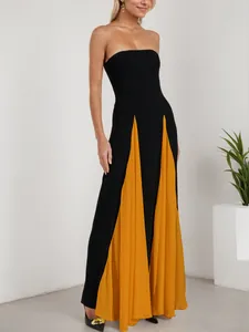 Full view of a sexy strapless evening gown featuring black and yellow pleated skirt detail.