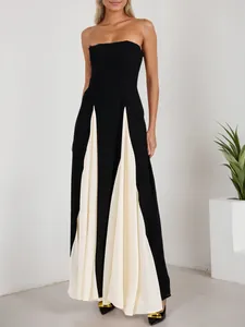Elegant strapless black and cream pleated maxi dress for evening parties and events.
