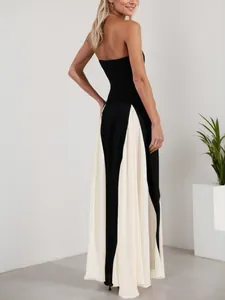 Elegant back view of a black strapless evening gown featuring cream pleated spliced details