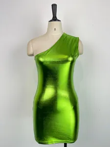 Close-up detail of a vibrant metallic lime green one-shoulder bodycon mini dress on mannequin.