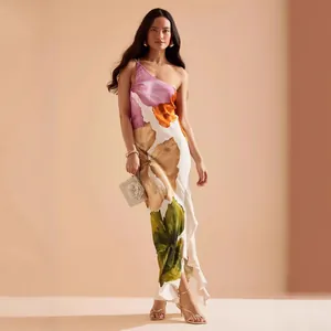 Elegant one-shoulder floral maxi dress featuring a ruffle hem and vibrant tropical print design