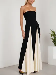 Elegant strapless color-block maxi dress with black bodice and white pleated skirt