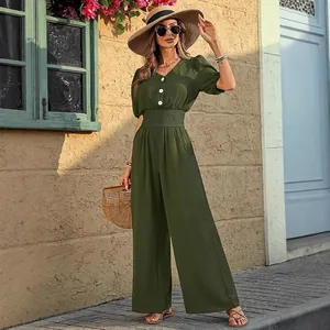 Detail view of an elegant olive green short sleeve wide leg jumpsuit with smocked waist